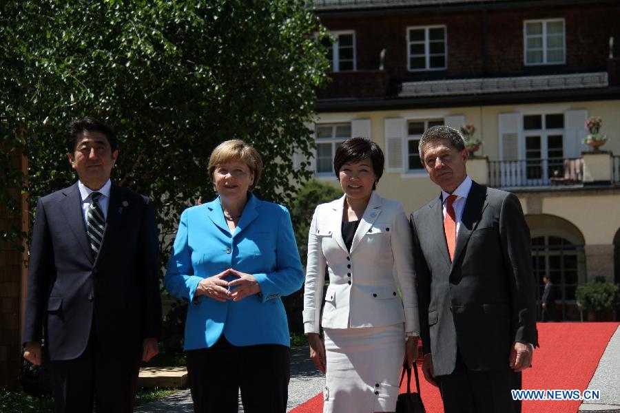 German Chancellor Angela Merkel (2nd L) welcomes Japanese Prime Minister Shinzo Abe (1st L) at the Elmau Castle near Garmisch-Partenkirchen, southern Germany, on June 7, 2015. 