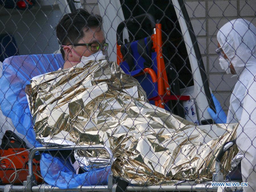 A medical worker loads a suspected MERS patient into an ambulance in Bratislava, Slovakia, June 13, 2015.