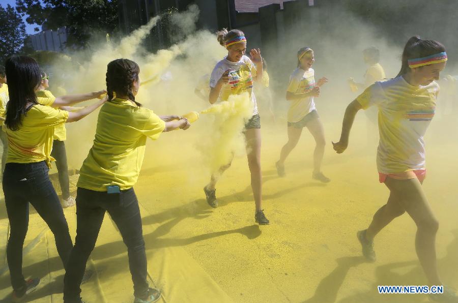 Runners are sprayed with colour powder during the colour run held in Vancouver, Canada, June 13, 2015. 