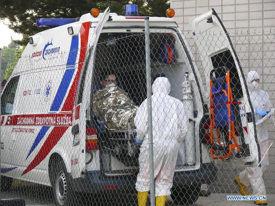 Medical workers load a suspected MERS patient into an ambulance in Bratislava, Slovakia, June 13, 2015. 