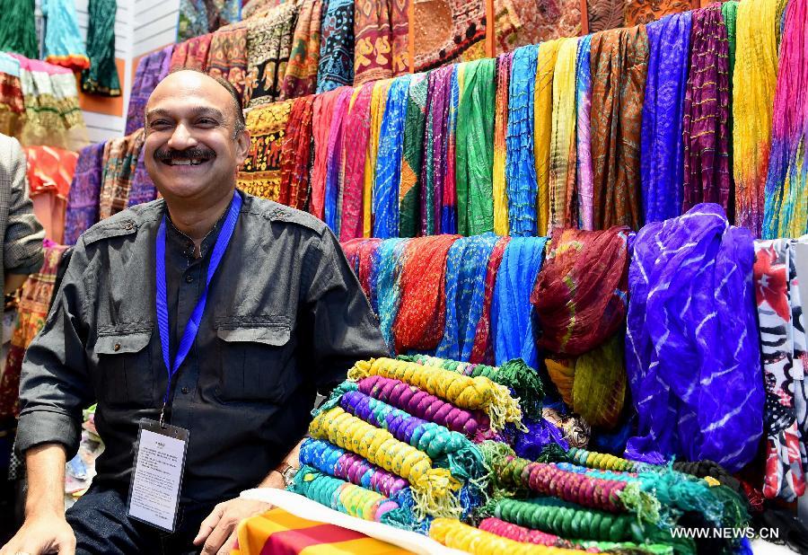 An Indian exhibitor sells tippets during the 23rd Kunming Import and Export Fair in Kunming, capital of southwest China's Yunnan Province, June 15, 2015.