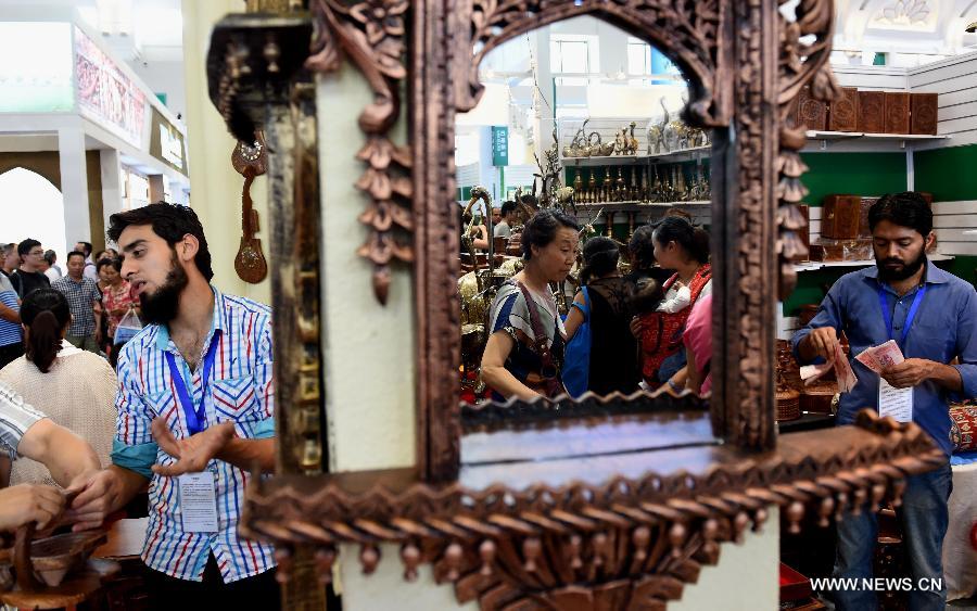 Pakistan exhibitors sell handicrafts during the 23rd Kunming Import and Export Fair in Kunming, capital of southwest China's Yunnan Province, June 15, 2015.