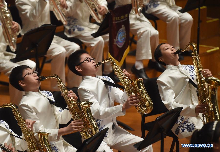 Bandsmen of a student wind band from Beijing No. 2 Experimental Primary School perform at the National Center for the Performing Arts in Beijing, capital of China, June 16, 2015. 