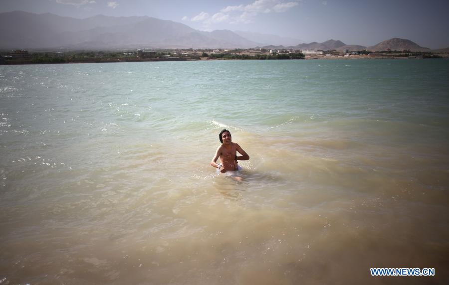 An Afghan boy cools off himself in the water in Kabul, Afghanistan, June 15, 2015