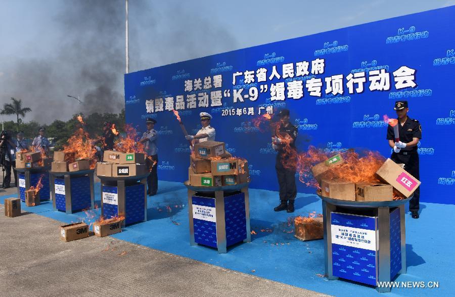 Police officers destroy drugs seized in drug busts at a launching ceremony of an anti-drugs campaign in Guangzhou, capital of south China's Guangdong Province, June 15, 2015.