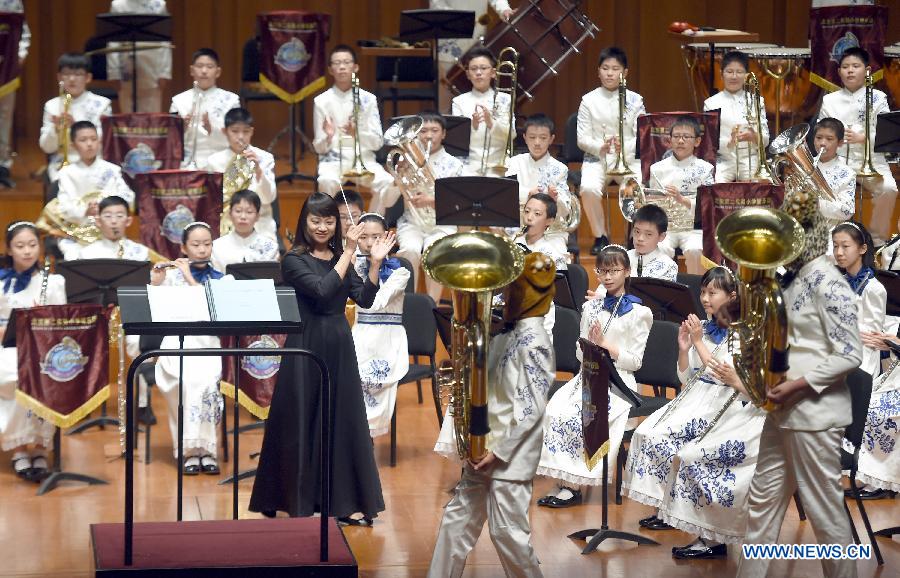 Bandsmen of a student wind band from Beijing No. 2 Experimental Primary School perform at the National Center for the Performing Arts in Beijing, capital of China, June 16, 2015.