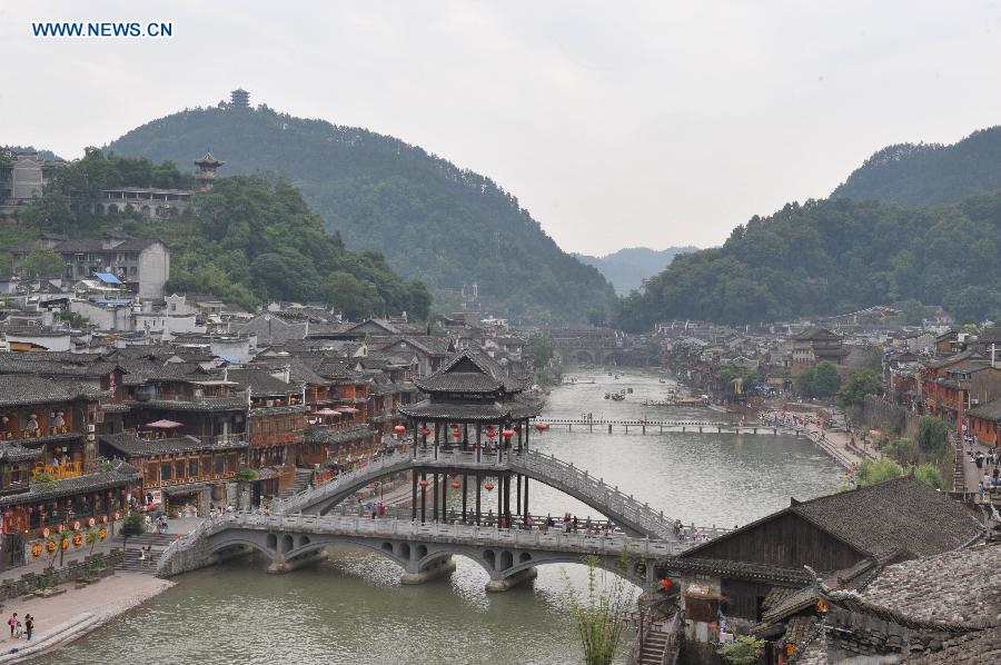 Photo taken on June 17, 2015 shows the ancient town of Fenghuang shrouded in fog in central China's Hunan Province. 