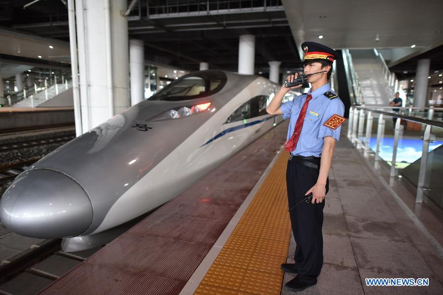 A CH380 high-speed train pulls out during a trial operaton at the Guiyang North Railway Station in Guiyang, capital of southwest China's Guizhou Province, June 17, 2015. 