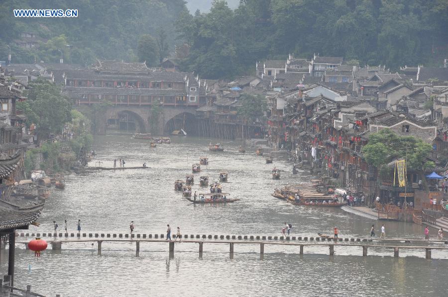 Photo taken on June 17, 2015 shows the ancient town of Fenghuang shrouded in fog in central China's Hunan Province. 