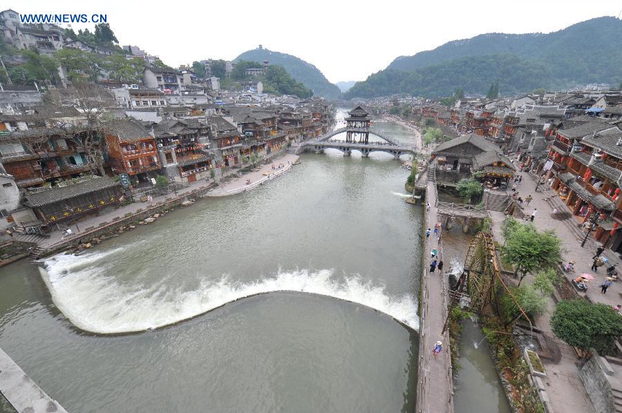 Photo taken on June 17, 2015 shows the ancient town of Fenghuang shrouded in fog in central China's Hunan Province. 