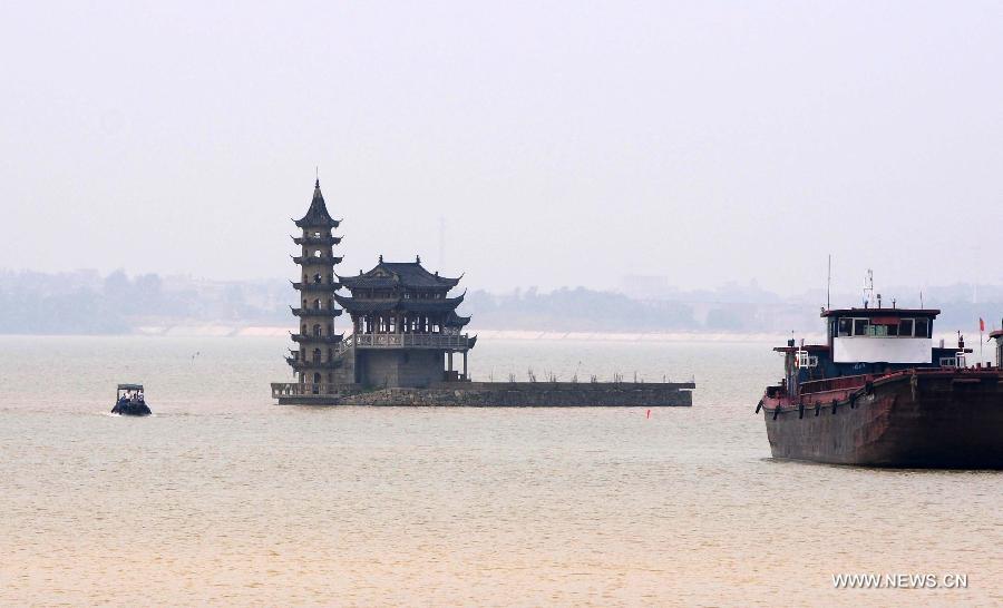 Boats move in the Xingzi water area of Poyang Lake in east China's Jiangxi Province, June 19, 2015.