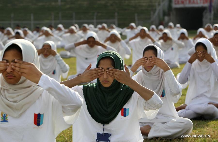 Kashmiri school children practise yoga on the first International Yoga Day in Srinagar, summer capital of Indian-controlled Kashmir, June 21, 2015.