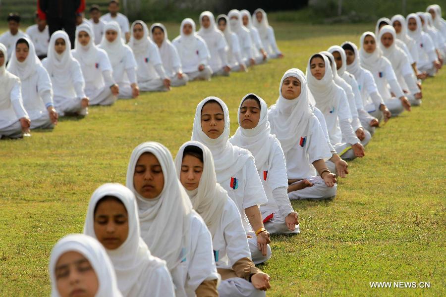 Kashmiri school children practise yoga on the first International Yoga Day in Srinagar, summer capital of Indian-controlled Kashmir, June 21, 2015.