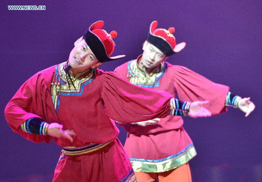 Dancers perform in a folk dance drama in Hohhot, capital city of north China's Inner Mongolia Autonomous Region, June 26, 2015.