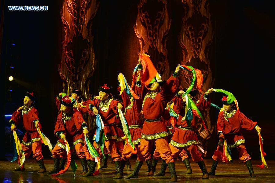 Dancers perform in a folk dance drama in Hohhot, capital city of north China's Inner Mongolia Autonomous Region, June 26, 2015.