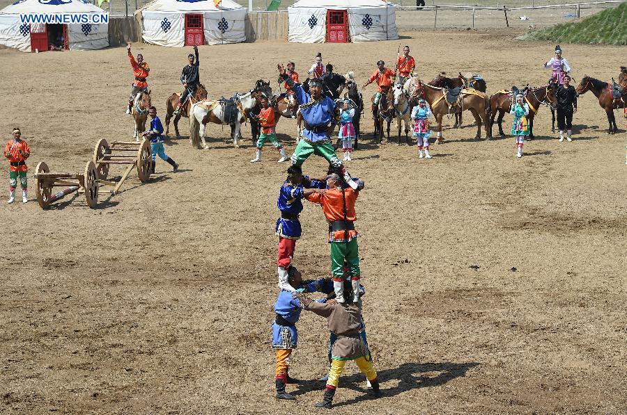 Artists perform in a race course in Hohhot, capital of north China's Inner Mongolia Autonomous Region, July 8, 2015. 