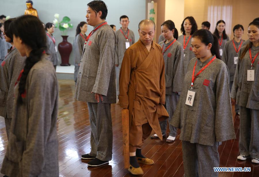 Citizens take part in a Zen class in the Yufo Temple, or Jade Buddha Temple, in Shanghai, east China, July 8, 2015.