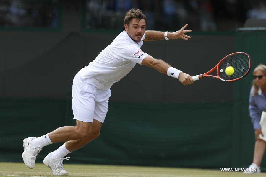 Stan Wawrinka of Switzerland servess a ball during men's quarterfinal match against Richard Gasquet of France at the 2015 Wimbledon Championships in Wimbledon, southwest London, July 8, 2015. Gasquet won the game 6-4, 4-6, 3-6, 6-4 and 11-9. (Xinhua/Ye Pingfan)