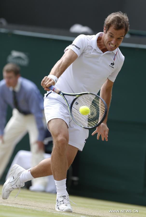 Stan Wawrinka of Switzerland servess a ball during men's quarterfinal match against Richard Gasquet of France at the 2015 Wimbledon Championships in Wimbledon, southwest London, July 8, 2015. Gasquet won the game 6-4, 4-6, 3-6, 6-4 and 11-9. (Xinhua/Ye Pingfan)