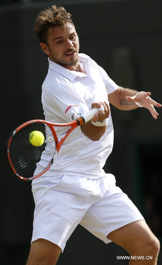 Stan Wawrinka of Switzerland servess a ball during men's quarterfinal match against Richard Gasquet of France at the 2015 Wimbledon Championships in Wimbledon, southwest London, July 8, 2015. Gasquet won the game 6-4, 4-6, 3-6, 6-4 and 11-9. (Xinhua/Ye Pingfan)