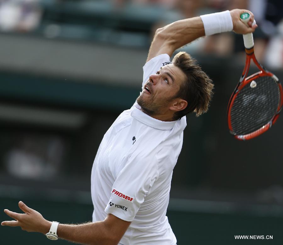 Stan Wawrinka of Switzerland servess a ball during men's quarterfinal match against Richard Gasquet of France at the 2015 Wimbledon Championships in Wimbledon, southwest London, July 8, 2015. Gasquet won the game 6-4, 4-6, 3-6, 6-4 and 11-9. (Xinhua/Ye Pingfan)