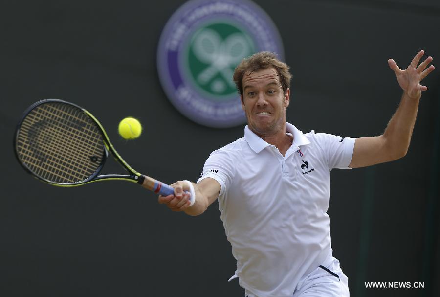 Stan Wawrinka of Switzerland servess a ball during men's quarterfinal match against Richard Gasquet of France at the 2015 Wimbledon Championships in Wimbledon, southwest London, July 8, 2015. Gasquet won the game 6-4, 4-6, 3-6, 6-4 and 11-9. (Xinhua/Ye Pingfan)