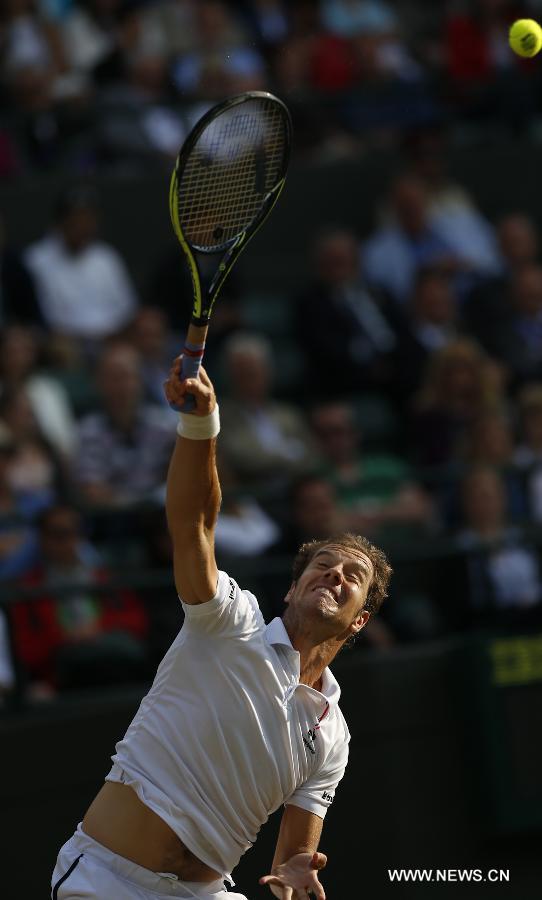 Stan Wawrinka of Switzerland servess a ball during men's quarterfinal match against Richard Gasquet of France at the 2015 Wimbledon Championships in Wimbledon, southwest London, July 8, 2015. Gasquet won the game 6-4, 4-6, 3-6, 6-4 and 11-9. (Xinhua/Ye Pingfan)