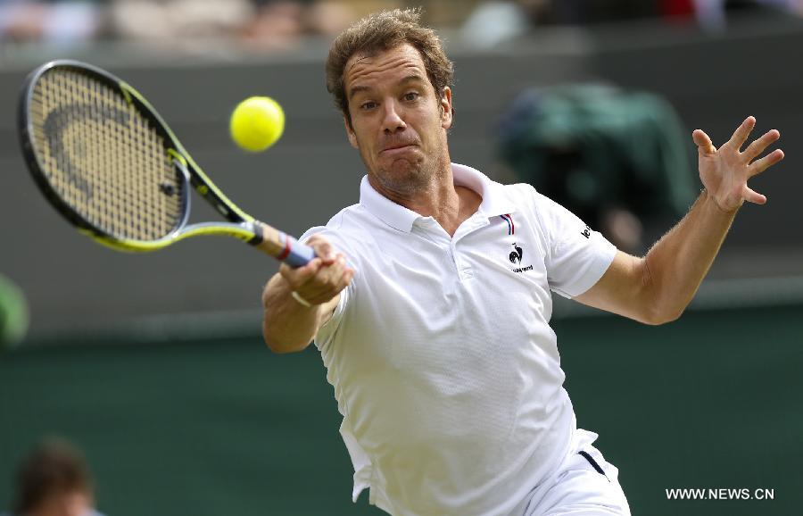 Stan Wawrinka of Switzerland servess a ball during men's quarterfinal match against Richard Gasquet of France at the 2015 Wimbledon Championships in Wimbledon, southwest London, July 8, 2015. Gasquet won the game 6-4, 4-6, 3-6, 6-4 and 11-9. (Xinhua/Ye Pingfan)