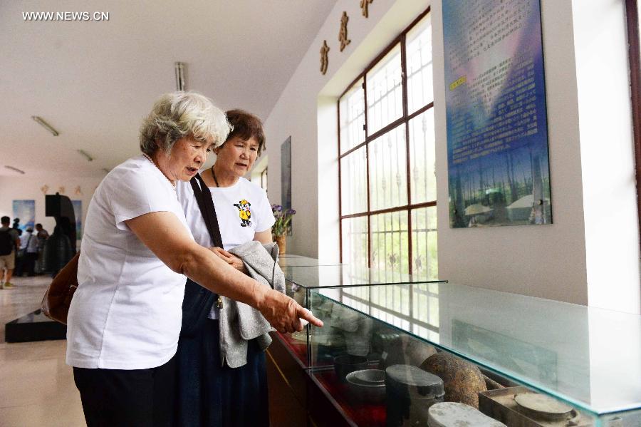 Japanese citizens, who were adopted by Chinese people during the World War II, visit a memorial hall as they visit a cemetery to memorize adoptive Chinese parents in Fangzheng County near Harbin, capital of northeast China's Heilongjiang Province, July 13, 2015. 