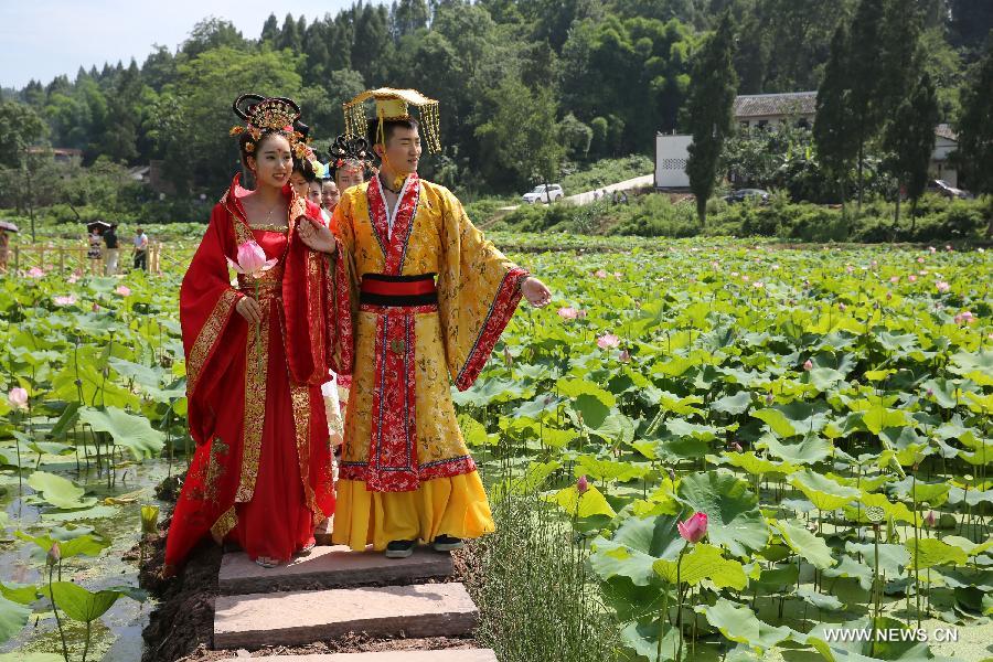 Actors dressed as an ancient imperial family are seen at a local lotus festival at Yangling Village in Neijiang City, southwest China's Sichuan Province, July 16, 2015.