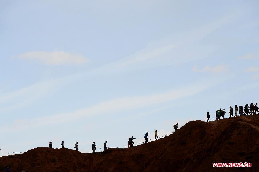 People visit the Danxia landform at the Zhangye Danxia National Geological Park in Zhangye, northwest China's Gansu Province, July 16, 2015. (Xinhua/Qiao Qiming) 