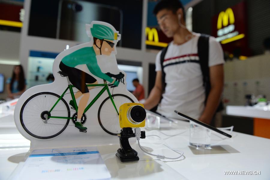 A visitor watches sport cameras based on mobile technology during the Mobile World Congress Shanghai in Shanghai, east China, July 17, 2015. 