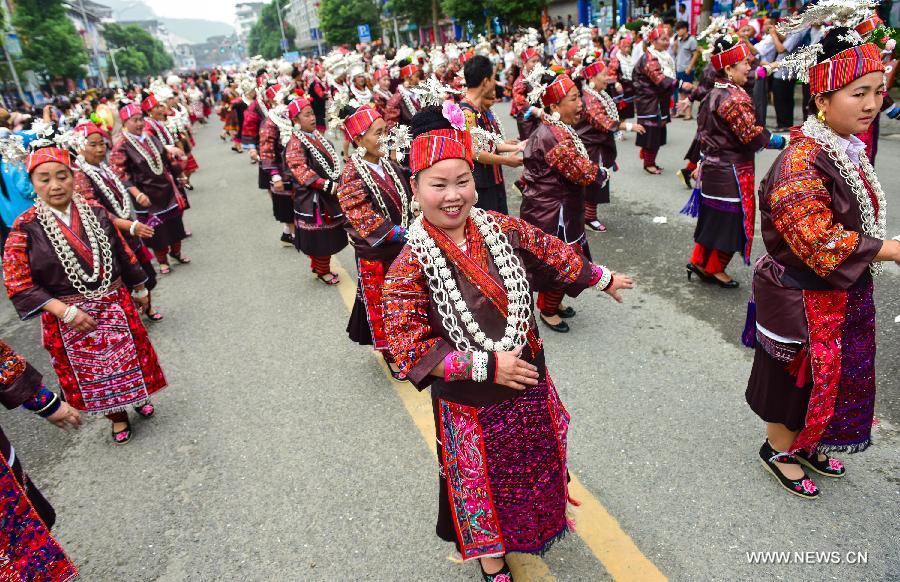 People in traditional costumes attend a parade during the Yang'esha Cultural Festival in Jianhe County, southwest China's Guizhou Province, July 21, 2015.