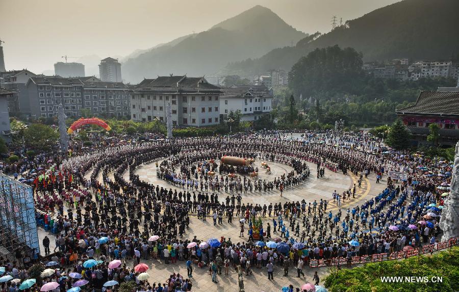 People perform a traditional dance during the Yang'esha Cultural Festival in Jianhe County, southwest China's Guizhou Province, July 21, 2015. 