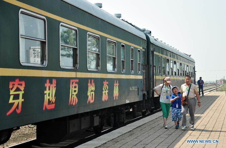 Passengers get off the sightseeing train at a station in Hulunbuir, north China's Inner Mongolia Autonomous Region, July 24, 2015.