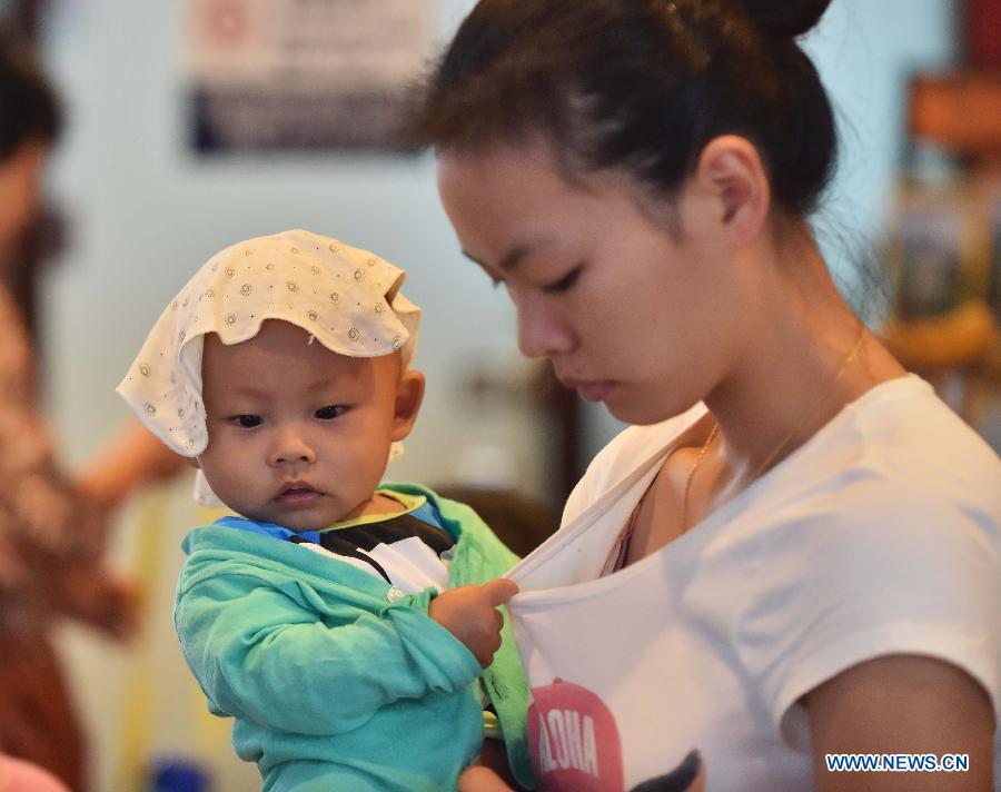 Passengers wait for boarding train at Beijing South Railway Station in Beijing, July 24, 2015. 