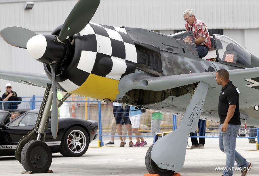 A visitor takes a close look at a vintage aircraft on display at the Boundary Bay air show in Delta, Canada, July 25, 2015. 