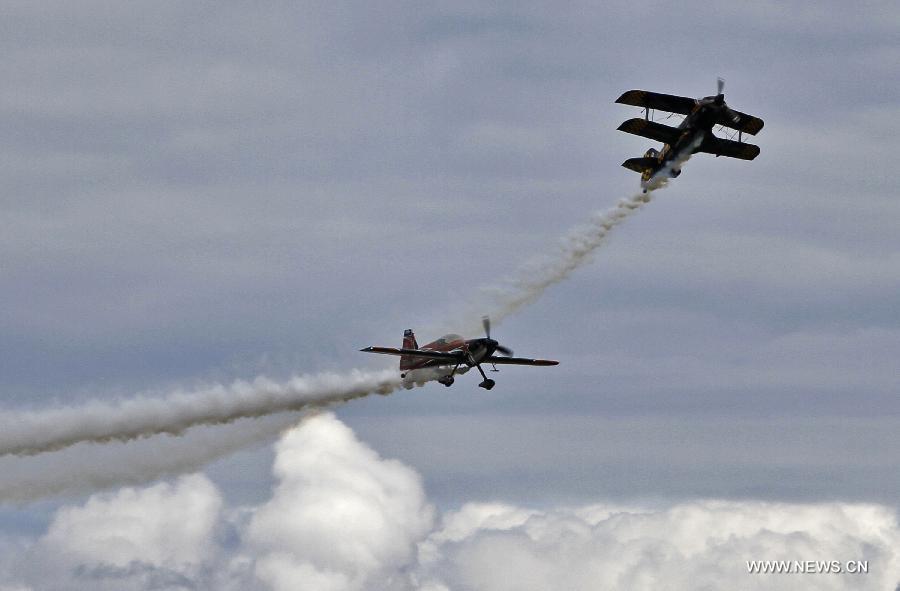 Two aircraft perform a flight demonstration in the sky at the Boundary Bay air show in Delta, Canada, Jul. 25, 2015.