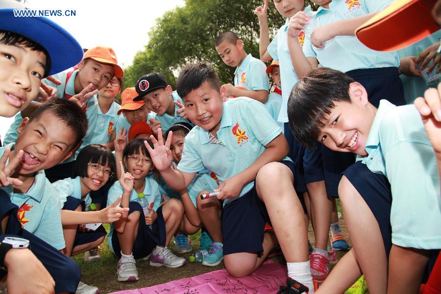 Campers pose for a photo during a summer camp in Beijing, capital of China, July 27, 2015.