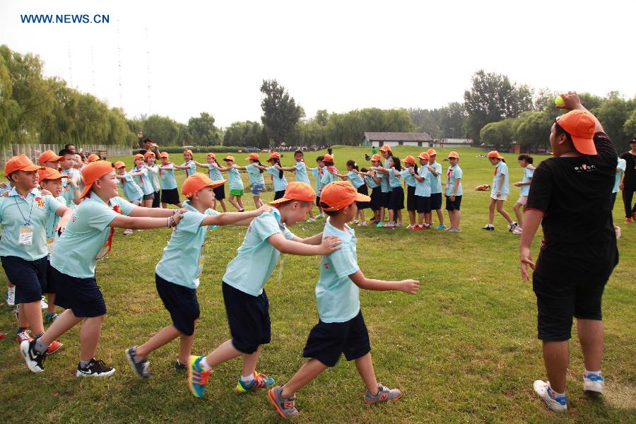 Campers take part in a group training during a summer camp in Beijing, capital of China, July 27, 2015. 