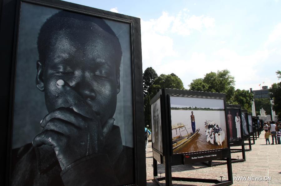 Photos are seen at the photographic show 'Infancia' by Spanish photographer Isabel Munoz, in the Heroic Youth Road of the Forest of Chapultepec, in Mexico City, capital of Mexico, on July 26, 2015.