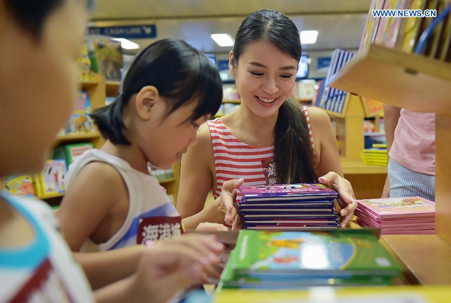 Visitors select books at Logos Hope in south China's Hong Kong, July 27, 2015.