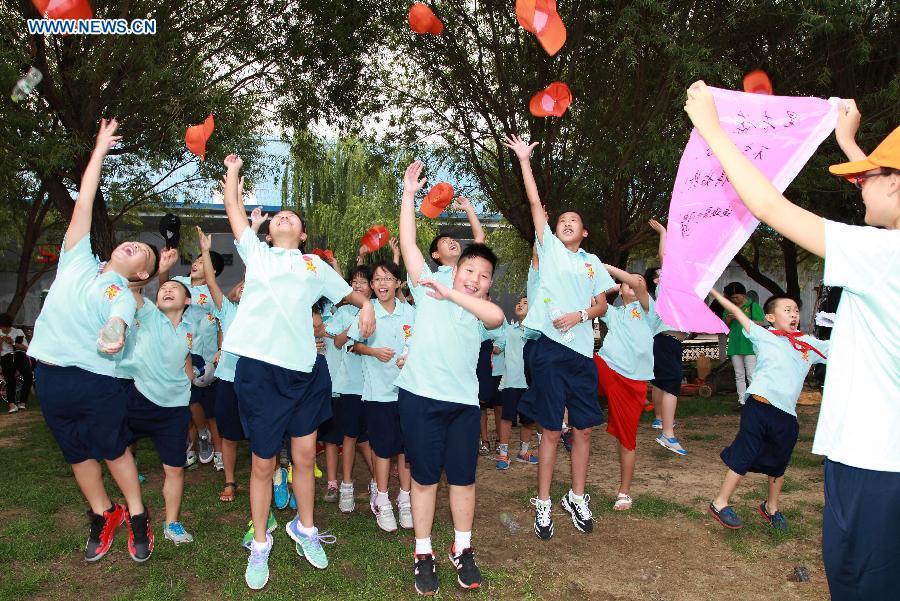 Campers play games during a summer camp in Beijing, capital of China, July 27, 2015. 