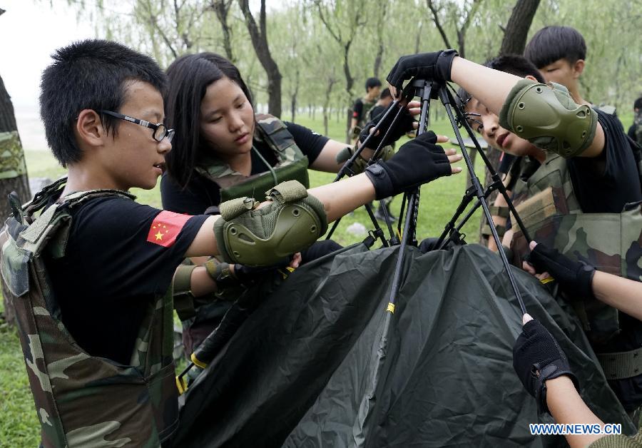 Students participate in a military summer camp in Beijing, capital of China, July 29, 2015. The military summer camp for youths, located in the Daxing District of Beijing, has attracted more than 15,000 students from across the country since 2008, when it was opened. (Xinhua/Li Xin) 