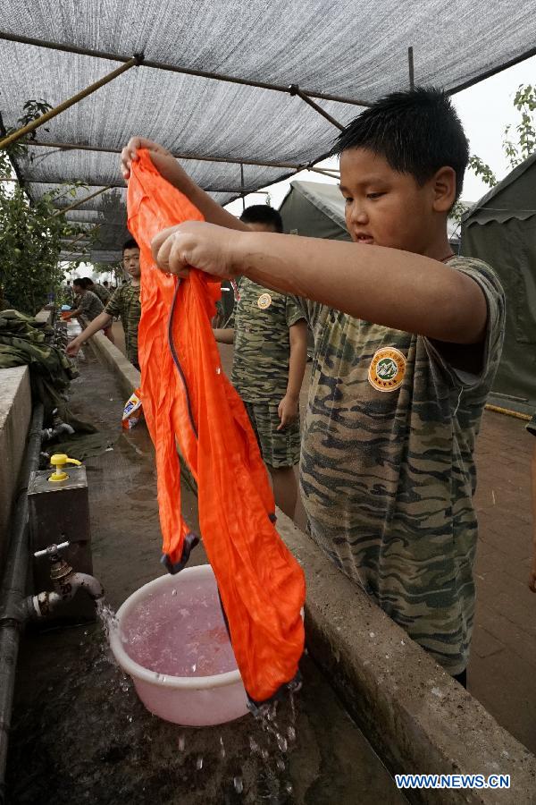 Students participate in a military summer camp in Beijing, capital of China, July 29, 2015. The military summer camp for youths, located in the Daxing District of Beijing, has attracted more than 15,000 students from across the country since 2008, when it was opened. (Xinhua/Li Xin) 