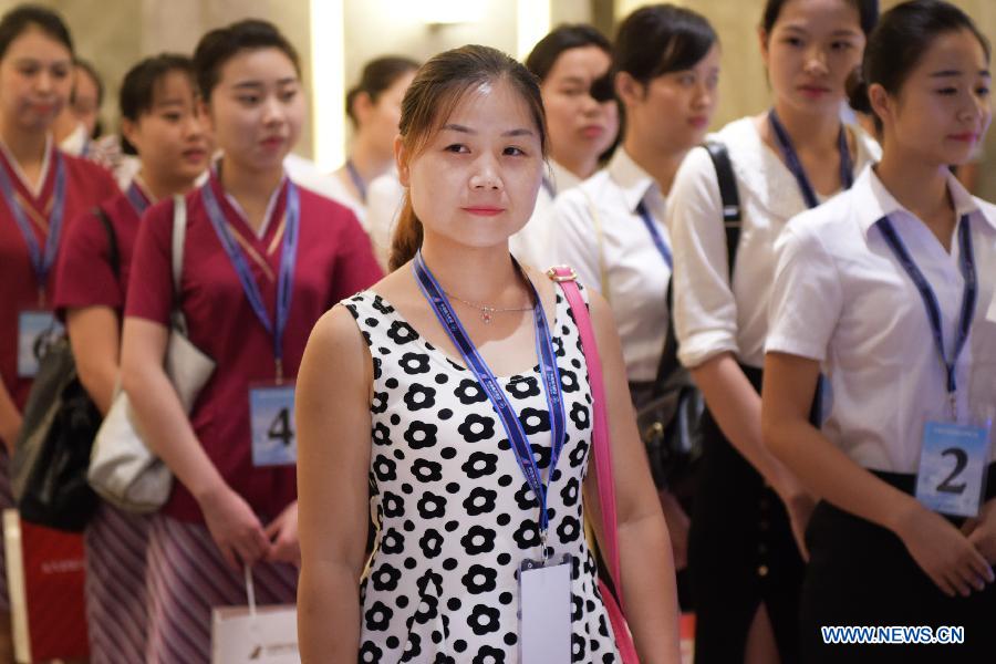 Candidates for flight attendant of China Southern Airlines wait to take part in the first round interview in Wuhan, capital of central China's Hubei Province, July 30, 2015. China Southern Airlines has extended the requirement of age for flight attendants to 30. (Xinhua/Cheng Min) 