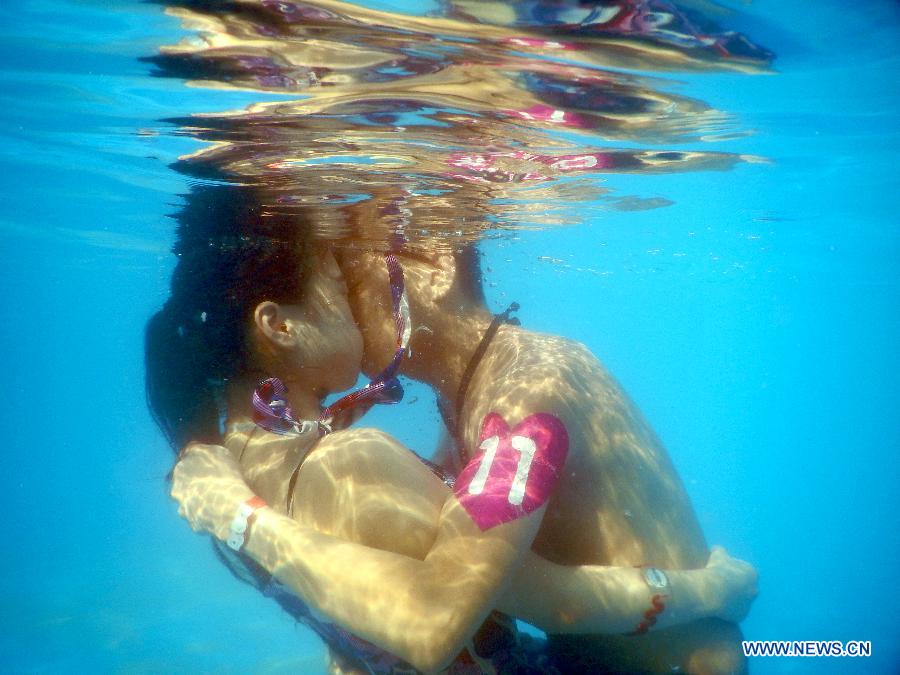 Participants take part in an underwater kissing contest in Wuhan, capital of central China's Hubei Province, Aug. 2, 2015.