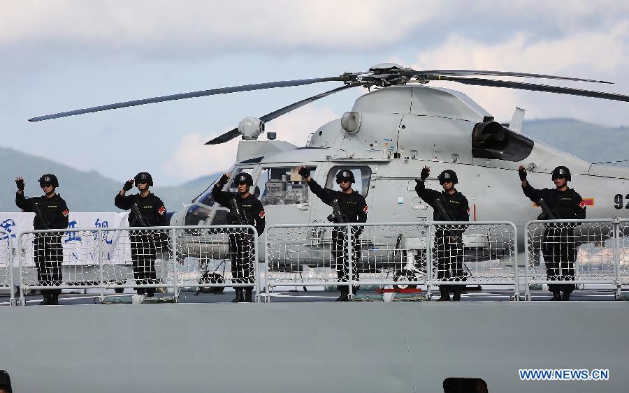 Chinese Navy soldiers wave to farewell at a naval port in Sanya, south China's Hainan Province, Agu. 4, 2015. 