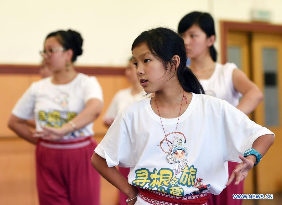 Youngsters practice the basic movements in traditional Chinese opera in National Academy of Chinese Theatre Arts in Beijing, capital of China, Aug. 4, 2015. 