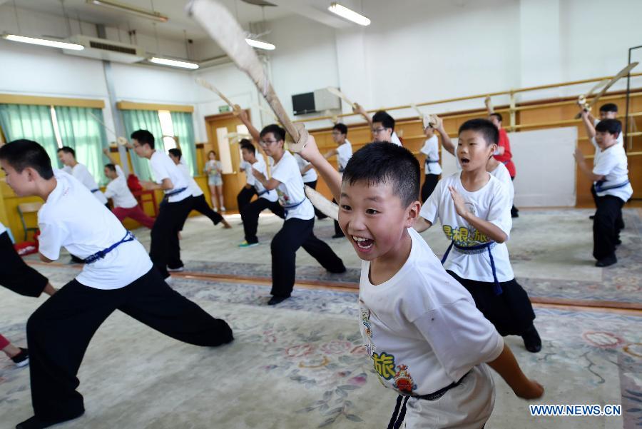 Youngsters practice the basic movements in traditional Chinese opera in National Academy of Chinese Theatre Arts in Beijing, capital of China, Aug. 4, 2015.